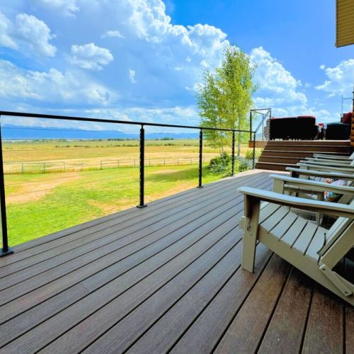 The expansive back deck is the perfect place to hang out with family, cook on the grill, and enjoy the spectacular view.