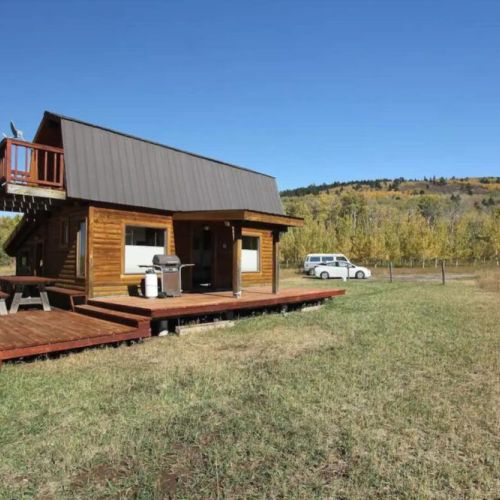 The home comes equipped with a deck, patio, picnic table, BBQ grill, and a hot tub — all your needs are covered!