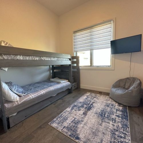 Bedroom #3 (located on the ground level) has a twin-over-twin bunk, plenty of closet space, and a TV — perfect for kids!