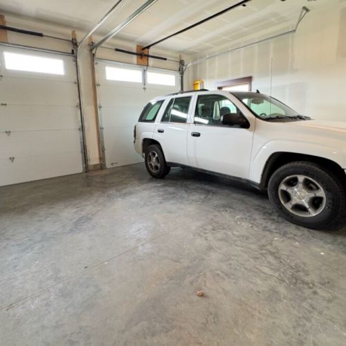 Keep your gear and your car dry using the available garage stall. (The owners stores their truck year-round on the side further from the home.)