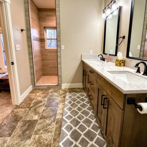 The primary en suite enjoys a spacious double vanity, a luxurious step-in shower, and access to the walk-in closet.