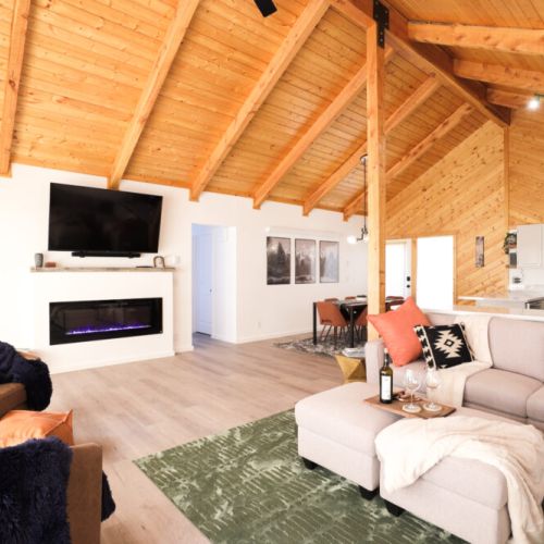 Kick back and relax in the living room, taking advantage of the cozy seating, a large smart TV, an electric fireplace, and a view of the Tetons.