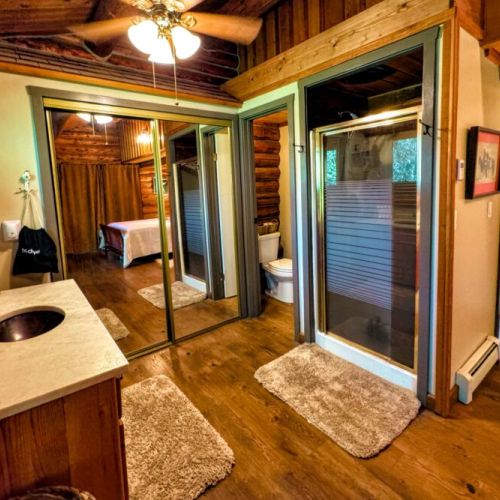 The primary bedroom (located on the ground level) has a queen bed and attached bath amenties.