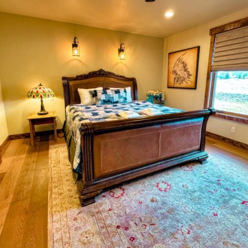 The master bedroom has a king bed and a huge en suite bath, as well as a large wardrobe, a TV, and a beautiful view of the Tetons.