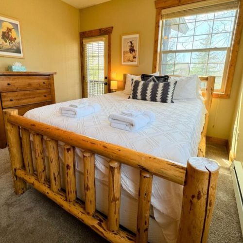 Bedroom #2 has a comfy queen bed with a large closet, a set of drawers, and great natural light.