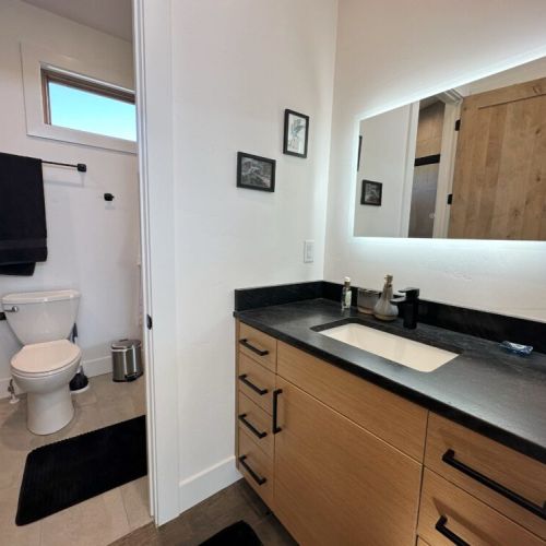 The master en suite features his-and-hers vanities and a luxurious walk-in shower.