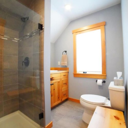 The recently renovated bathroom enjoys a large walk-in shower and a cozy vanity.