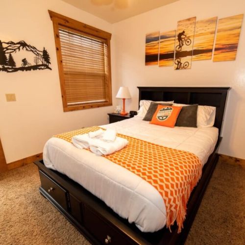 Bedroom #3 has a great queen bed and access to a porch shared with Bedroom #2. It also has a mounted TV.