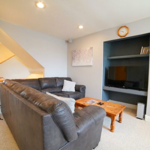 The 2nd floor features another living space, with a large sectional and a TV.