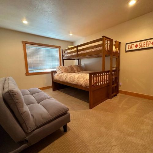 The downstairs bunk room enjoys a twin XL-over-queen bunk and a comfy futon. There is also a spacious closet to store your things!