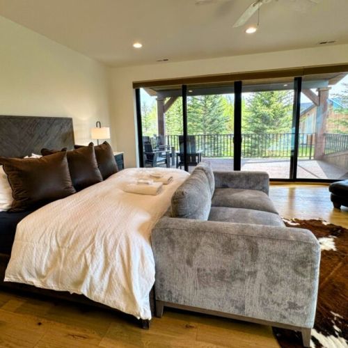 Bedroom #4 (upstairs) is functionally another master! It comes with a king bed, a love seat, a TV, a large en suite, as well as a fantastic balcony overlooking the backyard.