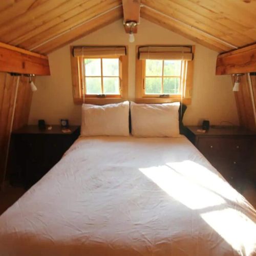 The bed is comfy, with dressers on either side to hold your belongings.