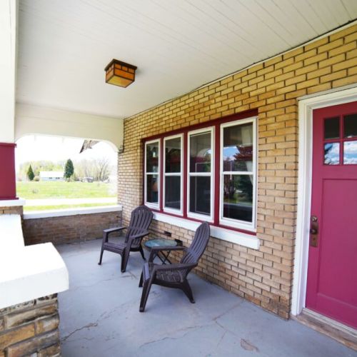 Enjoy spending time on the front porch — there is even a propane grill to use (not pictured).