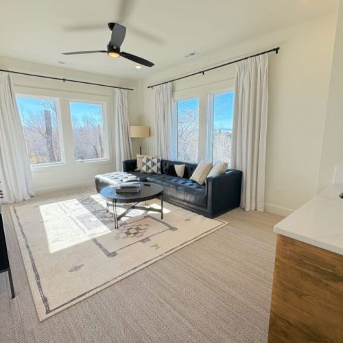 Also located upstairs is a beautiful sitting room, with tremendous natural light, an enormous TV, and a small wet bar.