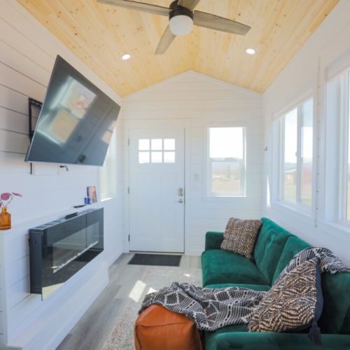 Living small does not mean going without — the smart TV and electric fireplace offer creature comforts not found in many other tiny homes.