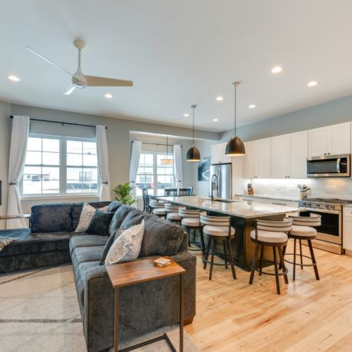 The spacious open-concept living area with cozy seating and seamless flow leads straight to the dining room and kitchen.