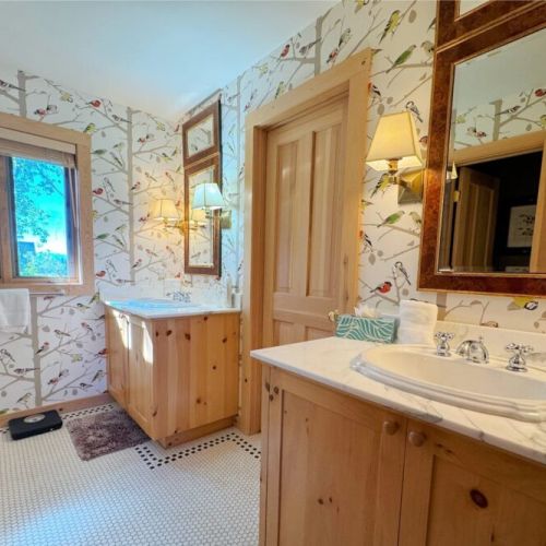 The master bedroom has a king bed, lovely sitting space,  a walk-in closet, and an en suite bath.