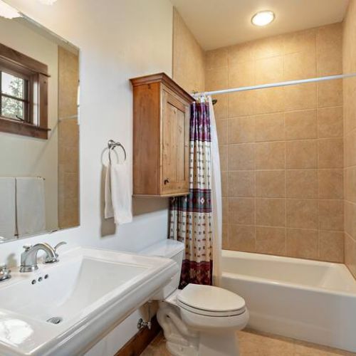 The master en suite enjoys a vanity and a large shower/tub.