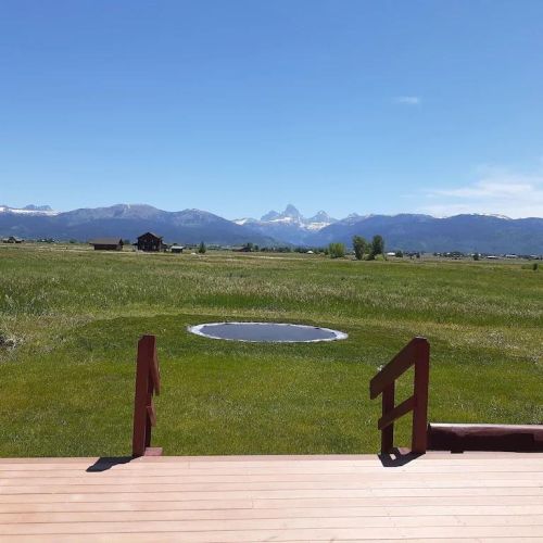 Playing on an in-ground trampoline in the shadow of the Tetons is a one-of-a-kind experience for kids (and adults, too)!